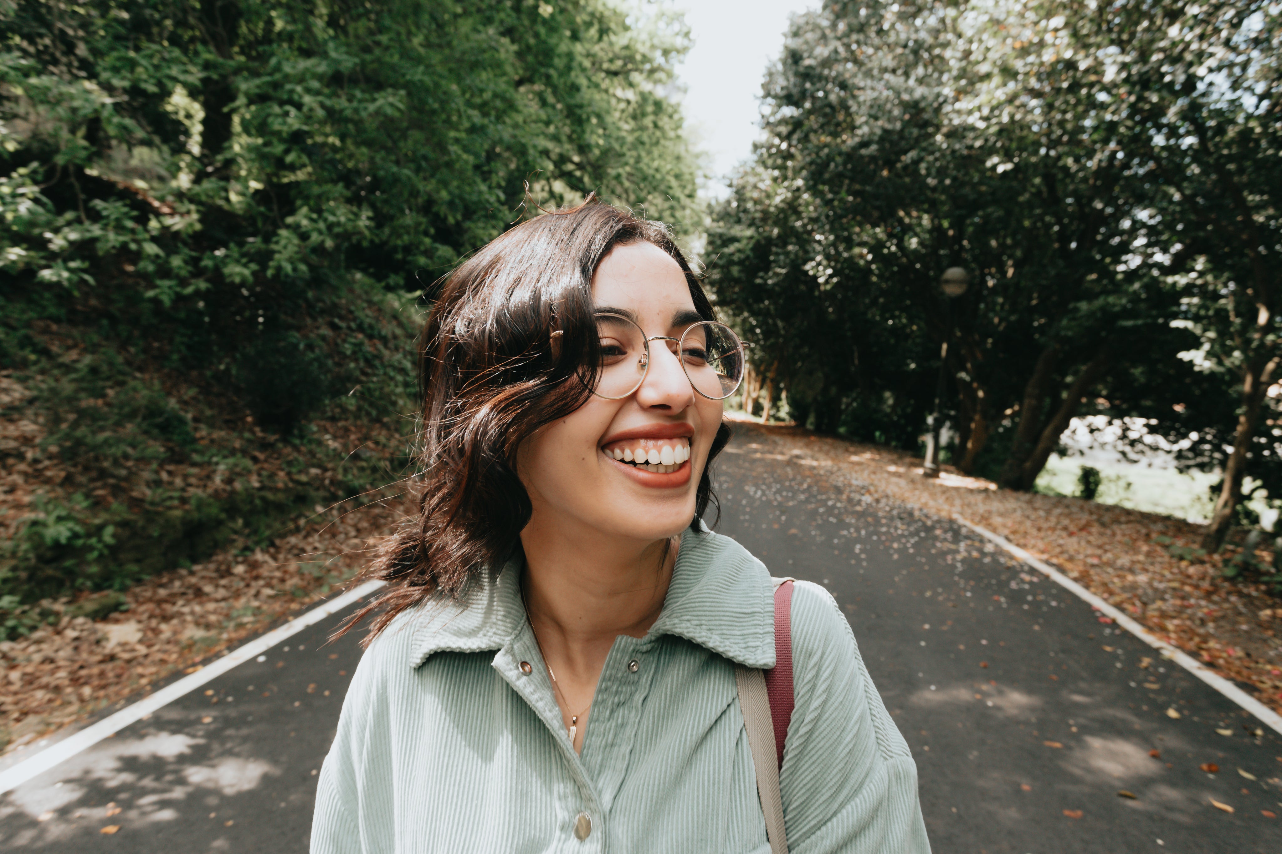 files/woman-in-a-blue-shirt-and-glasses-smiles-wide.jpg